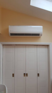 White Fujitsu air conditioning unit installed in a bedroom by PRA Air Conditioning Engineers