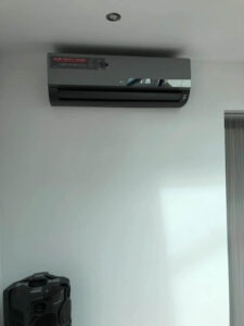 Black LG air conditioning unit installed on a wall by PRA Air Conditioning Engineers