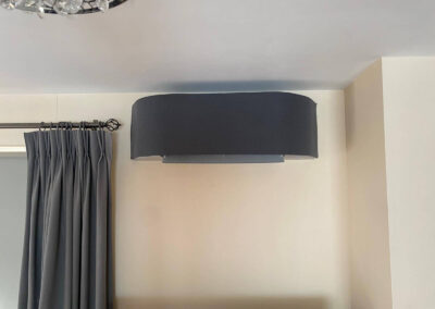 Dark grey air conditioning unit installed on a wall by PRA Air Conditioning Engineers