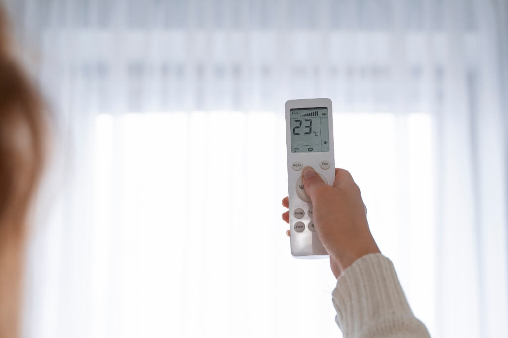 person using AC for heating